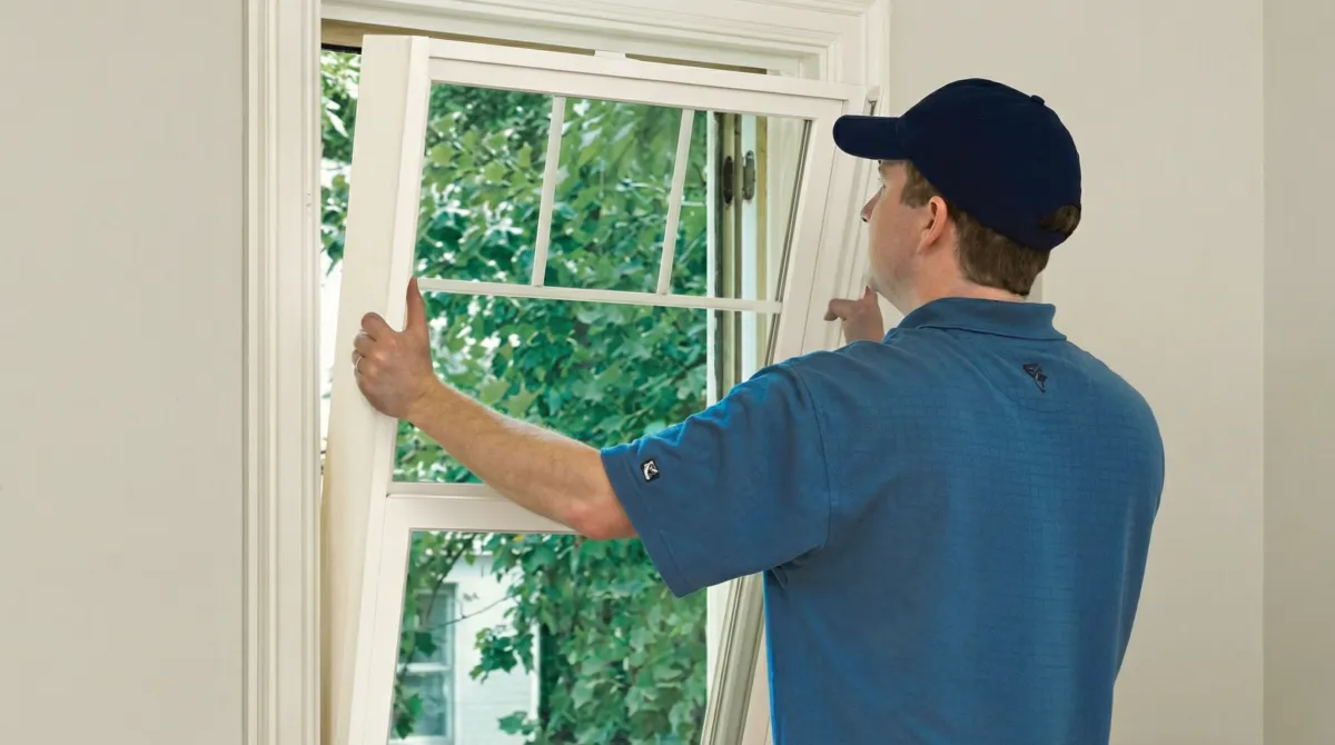 Professional contractors performing a residential window insulation and replacement service in Columbia, MO
